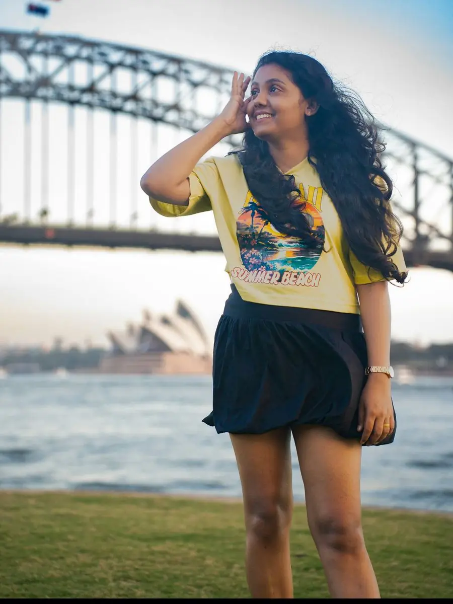 Woman at Sydney Harbour with the Opera House behind her